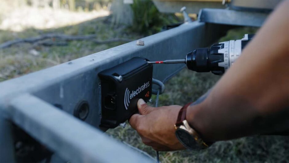 A close-up shot of a person's hands installing an Elecbrakes EB2 regenerative braking system. The image shows part of the braking system and emphasizes the installation process.